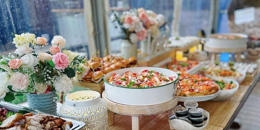 PHO HOME Vietnamese catering event setup with flowers and platters